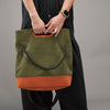 KAKAVY TRIO bag carried by its leather-trimmed cutout handles