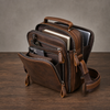 Open leather messenger bag showing organized compartments
