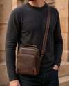 Man wearing a coffee brown leather messenger bag crossbody